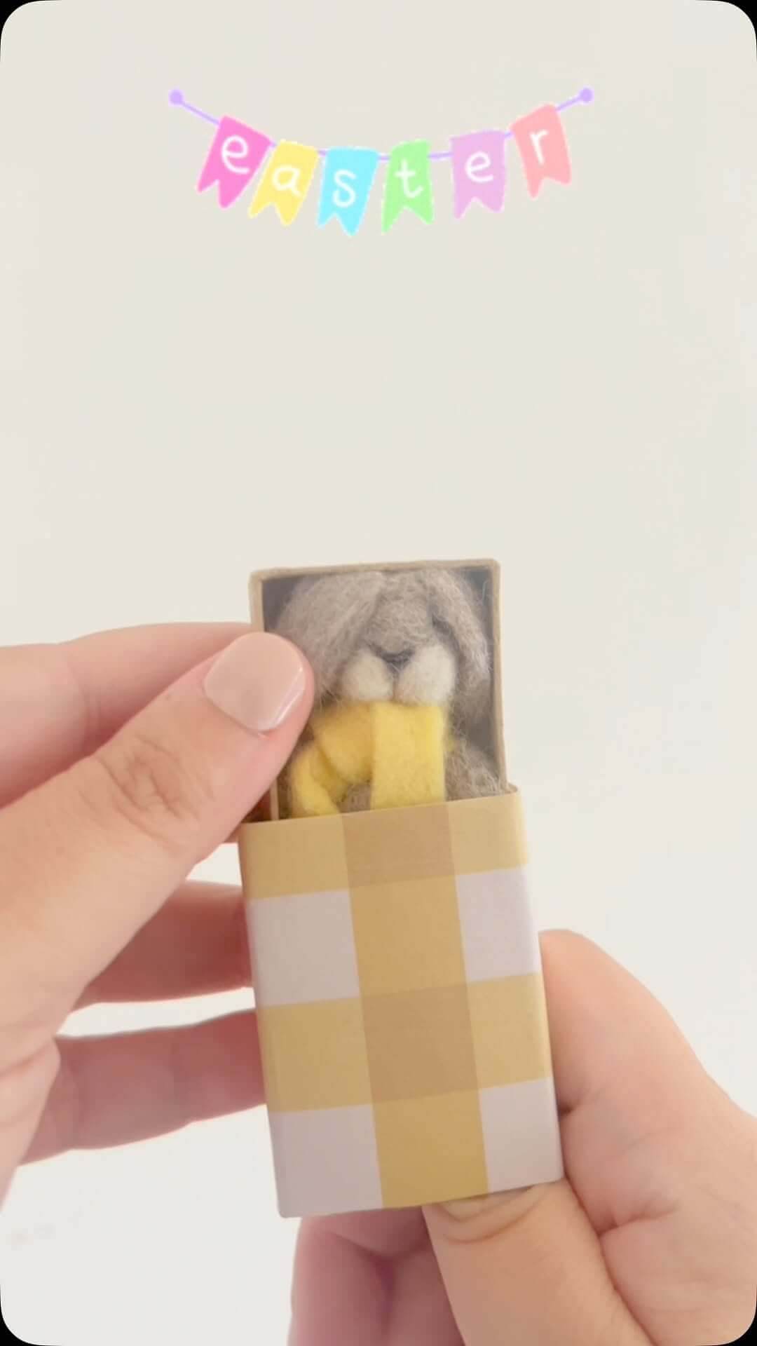 A needlefelt bunny in a matchbox